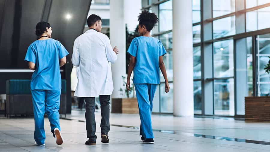 healthcare professionals walking in the lobby of a medical office building
